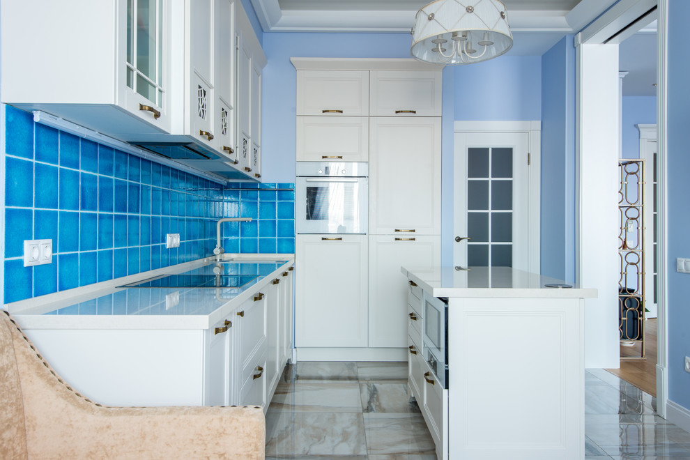 Photo of a transitional single-wall eat-in kitchen in Moscow with recessed-panel cabinets, white cabinets, blue splashback, white appliances, with island and beige floor.