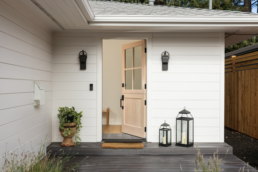 Inspiration for a traditional entrance in Orange County with a stable front door and a light wood front door.