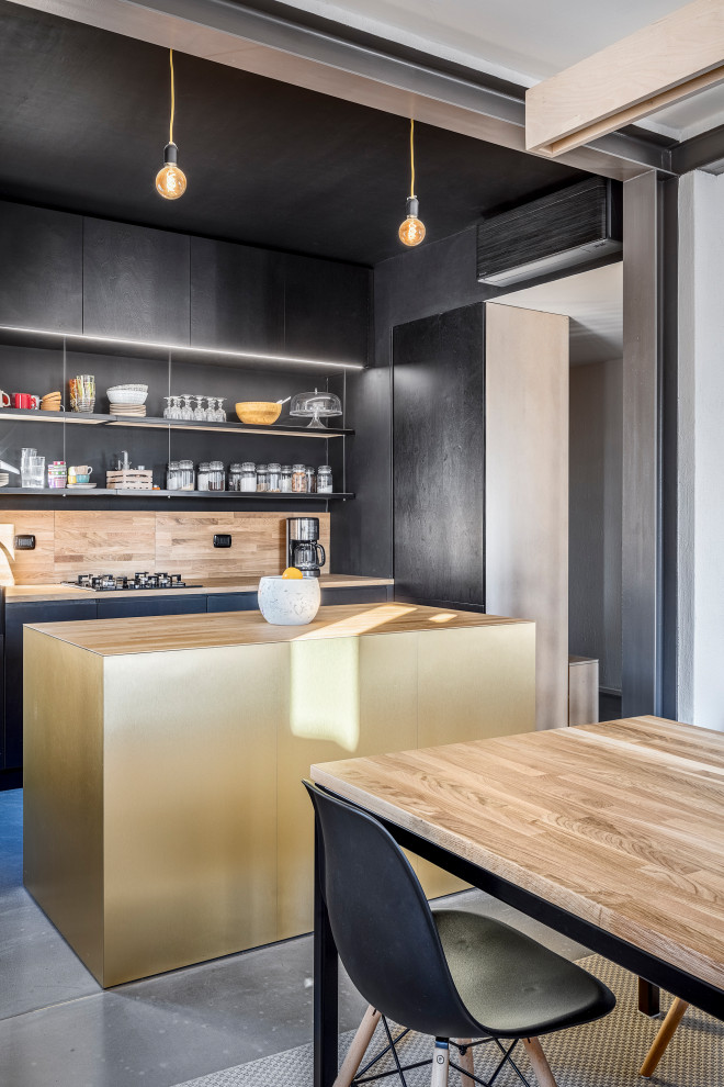 Design ideas for a mid-sized contemporary single-wall open plan kitchen in Other with a single-bowl sink, flat-panel cabinets, black cabinets, wood benchtops, timber splashback, concrete floors, with island, grey floor, beige splashback, panelled appliances and beige benchtop.