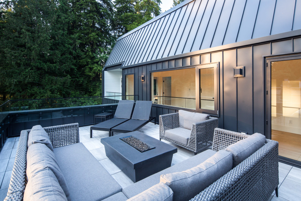 Large modern rooftop deck in Vancouver with a fire feature and no cover.