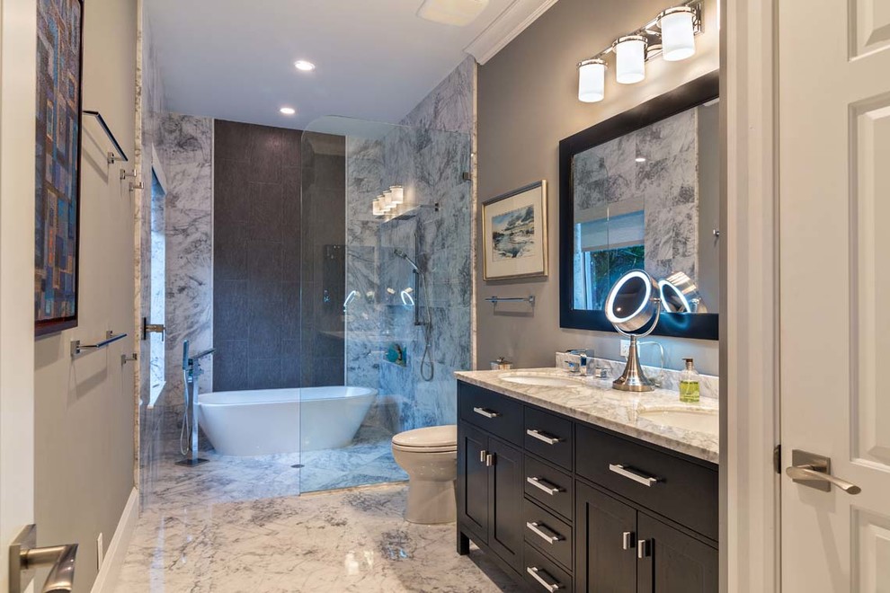 Photo of a large transitional master bathroom in Miami with shaker cabinets, black cabinets, a freestanding tub, an open shower, grey walls, an undermount sink, an open shower, gray tile, white tile, stone tile, marble floors and quartzite benchtops.