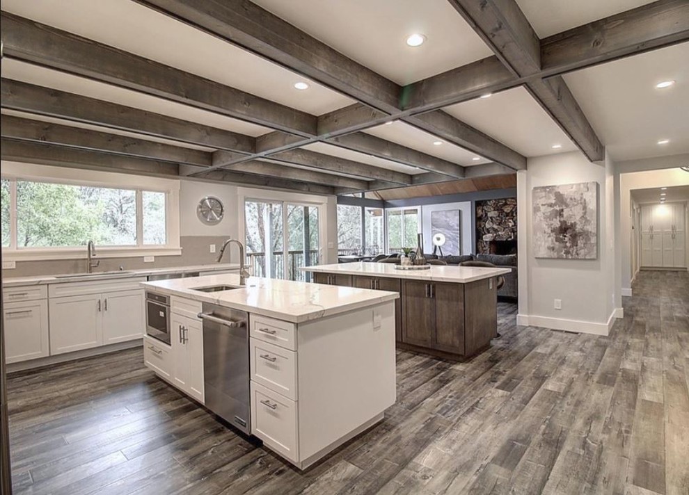 Large contemporary u-shaped eat-in kitchen in San Francisco with a single-bowl sink, recessed-panel cabinets, white cabinets, quartzite benchtops, white splashback, mosaic tile splashback, stainless steel appliances, light hardwood floors, no island, grey floor and white benchtop.