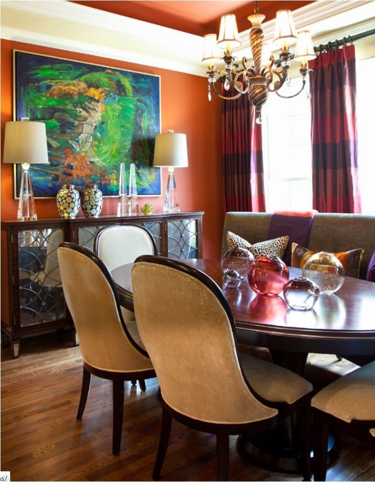 Photo of a mid-sized transitional separate dining room in Dallas with orange walls and medium hardwood floors.