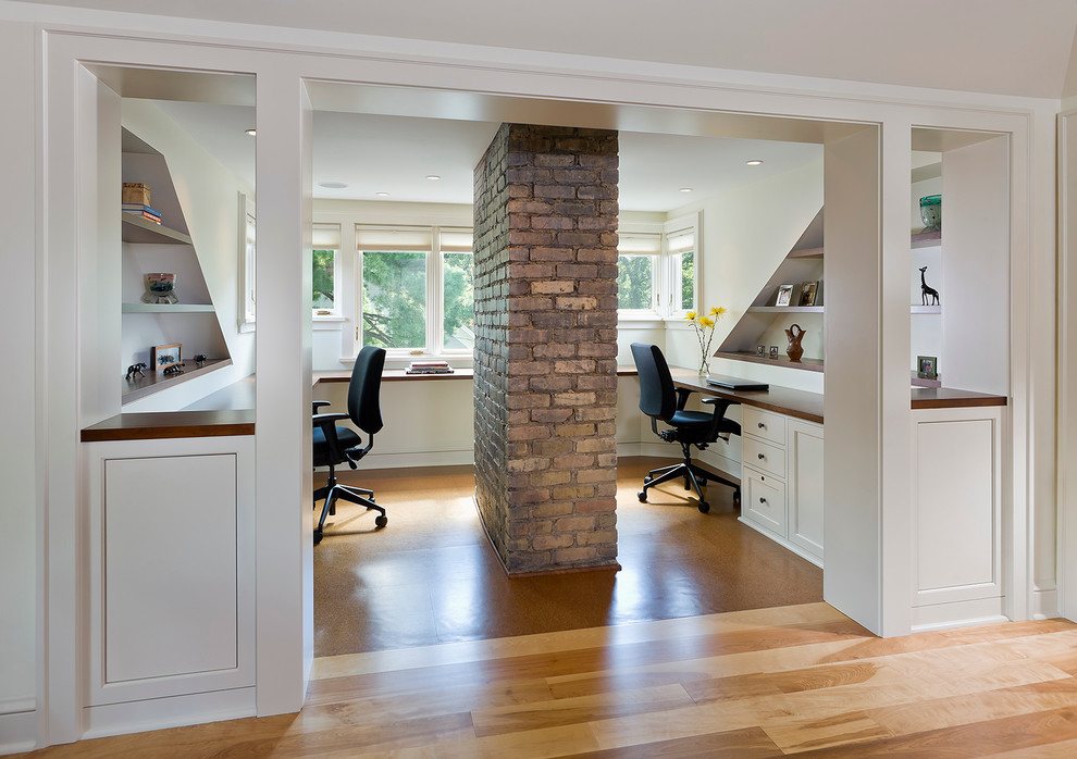 This is an example of a traditional home office in Minneapolis with a built-in desk.