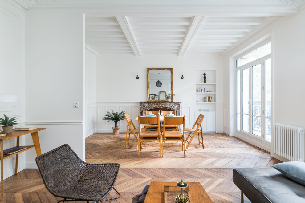 Inspiration for a large contemporary open plan dining in Paris with white walls, medium hardwood floors, a standard fireplace, a stone fireplace surround, brown floor, exposed beam and decorative wall panelling.