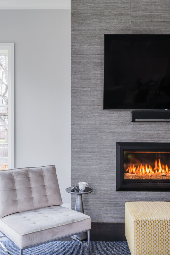 Design ideas for a large transitional open concept family room in Boston with a tile fireplace surround, grey walls, dark hardwood floors, a ribbon fireplace, a wall-mounted tv and brown floor.