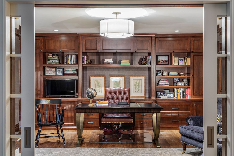 Photo of a traditional home office in Boston with medium hardwood floors, a freestanding desk and brown floor.