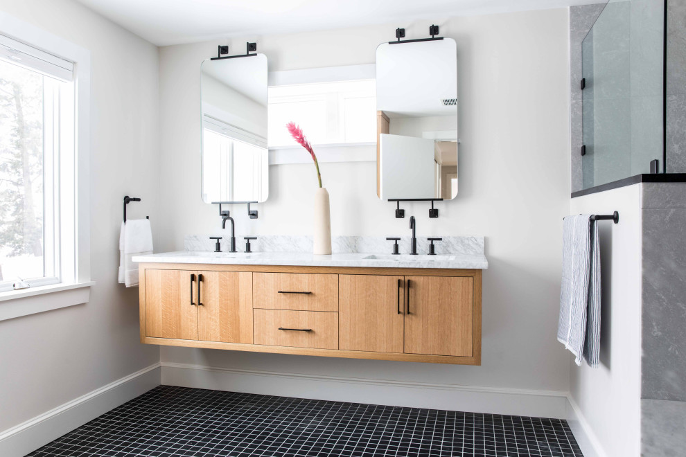 Immagine di una stanza da bagno padronale moderna di medie dimensioni con ante lisce, pareti bianche, pavimento con piastrelle in ceramica, top in marmo, pavimento nero, porta doccia a battente, due lavabi e mobile bagno sospeso