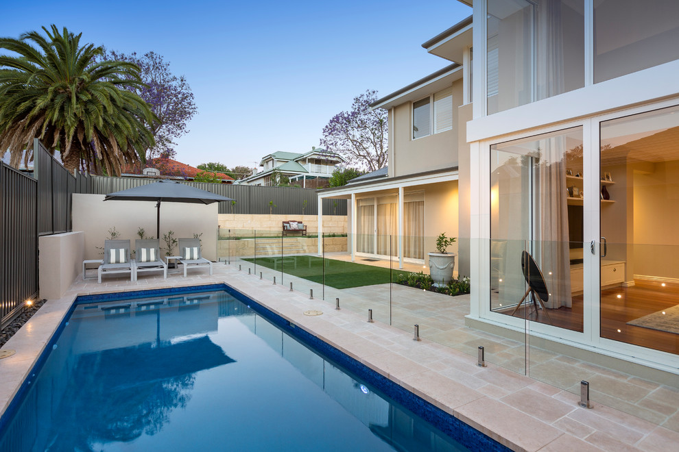 Transitional backyard rectangular lap pool in Perth with tile.