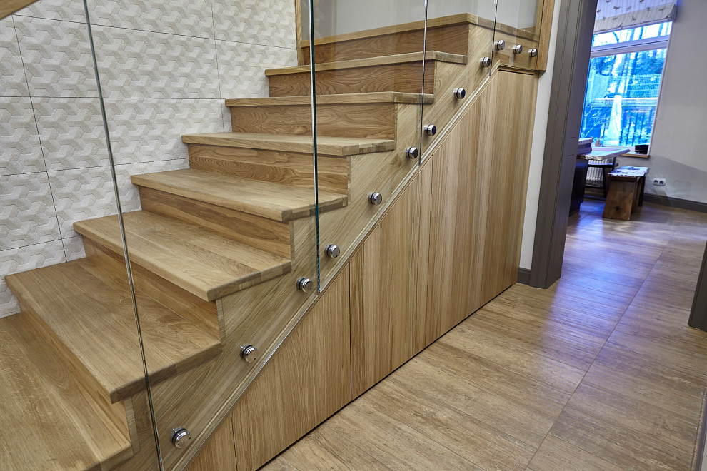 Inspiration for a mid-sized contemporary wood u-shaped staircase in Moscow with wood risers and mixed railing.