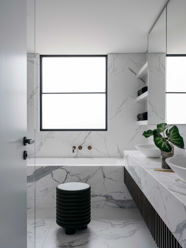 Contemporary bathroom in Sydney with an undermount tub, white tile, stone slab, a vessel sink, white floor and white benchtops.