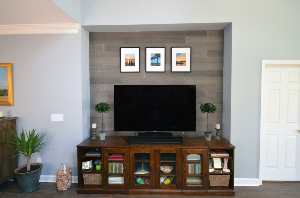 Photo of a beach style family room in Charlotte with a wall-mounted tv.