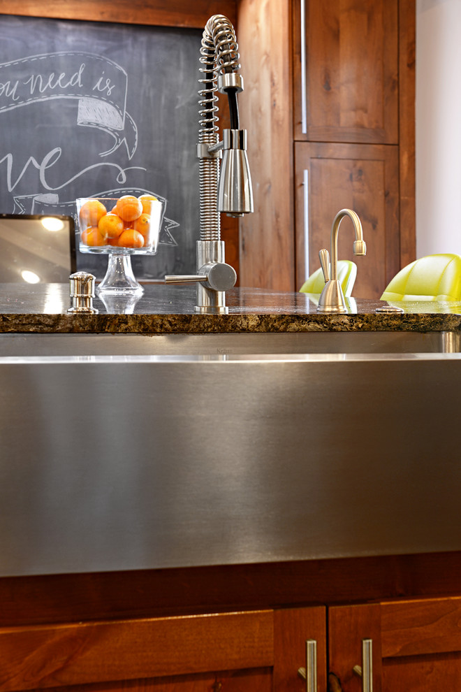 Example of a large transitional u-shaped travertine floor eat-in kitchen design in Dallas with a farmhouse sink, medium tone wood cabinets, granite countertops, multicolored backsplash, matchstick tile backsplash, stainless steel appliances and a peninsula