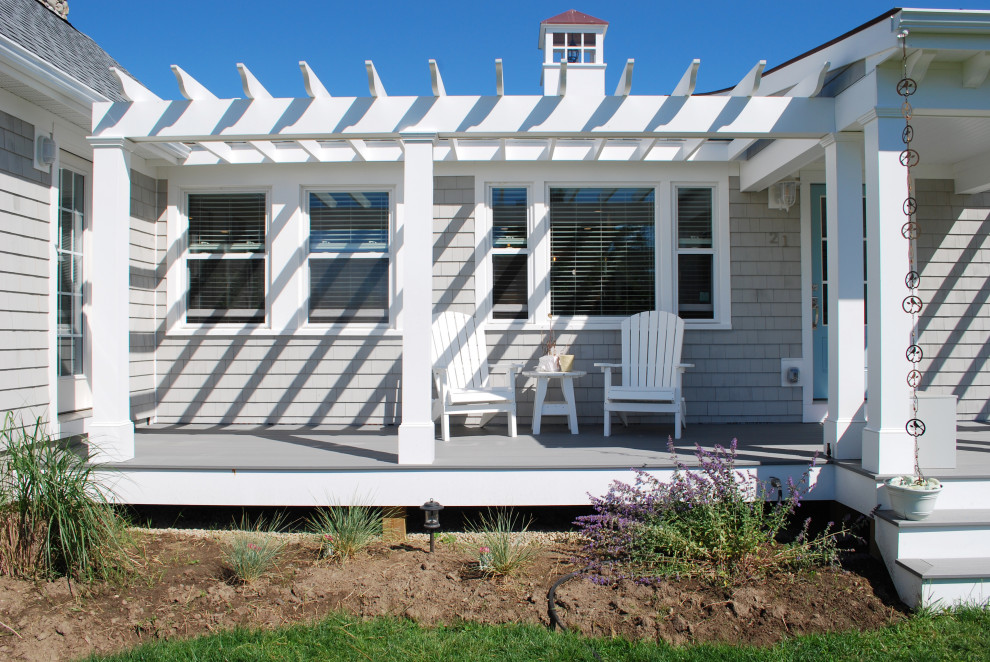 Mid-sized beach style front yard verandah in Providence with with columns and a pergola.