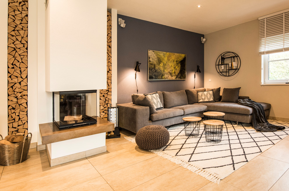 Mid-sized contemporary formal open concept living room in Munich with blue walls, ceramic floors, a standard fireplace, a plaster fireplace surround, a wall-mounted tv and beige floor.