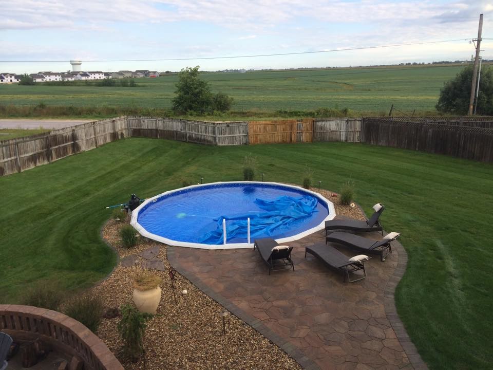 Backyard round aboveground pool photo in Cedar Rapids