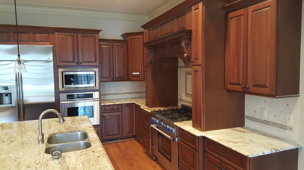 This is an example of a transitional kitchen in Raleigh with with island.