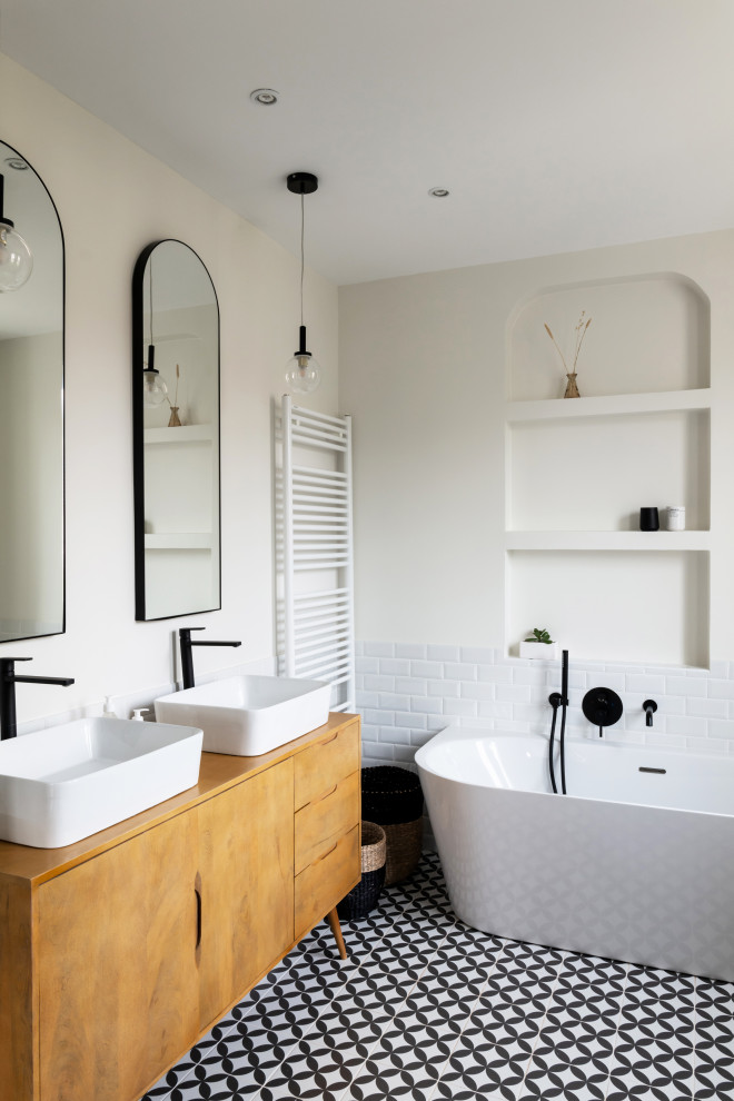 Design ideas for a large contemporary family bathroom in Paris with light wood cabinets, an alcove bath, an alcove shower, white tiles, ceramic tiles, white walls, ceramic flooring, a built-in sink, black floors, a sliding door, brown worktops, double sinks and a freestanding vanity unit.