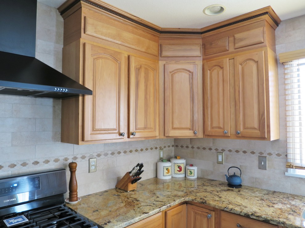 Mid-sized transitional u-shaped ceramic tile and white floor eat-in kitchen photo in Bridgeport with a double-bowl sink, raised-panel cabinets, light wood cabinets, granite countertops, white backsplash, subway tile backsplash, stainless steel appliances and an island