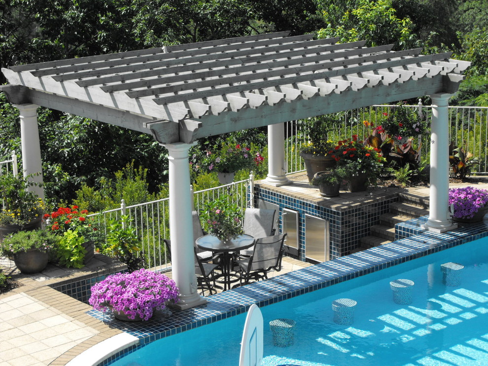 Photo of a mid-sized traditional backyard rectangular pool in Birmingham with concrete pavers.