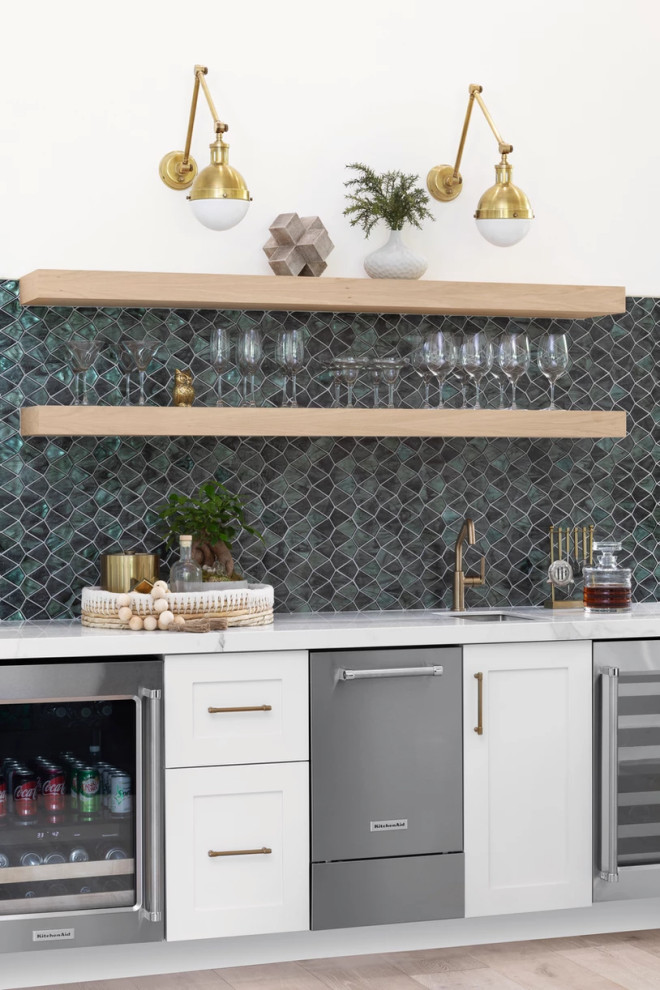 This is an example of a traditional single-wall home bar in Miami with a submerged sink, shaker cabinets, white cabinets, green splashback, mosaic tiled splashback, light hardwood flooring, beige floors and white worktops.