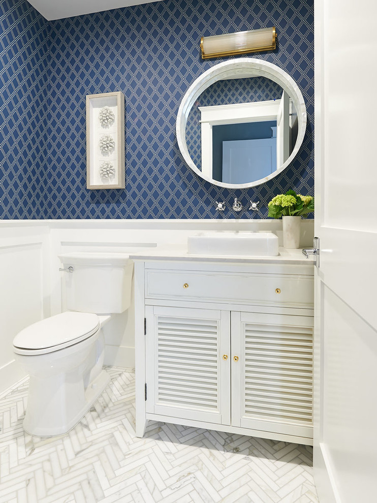 Design ideas for a beach style powder room in San Diego with furniture-like cabinets, white cabinets, a two-piece toilet, blue walls, a vessel sink, white floor and beige benchtops.