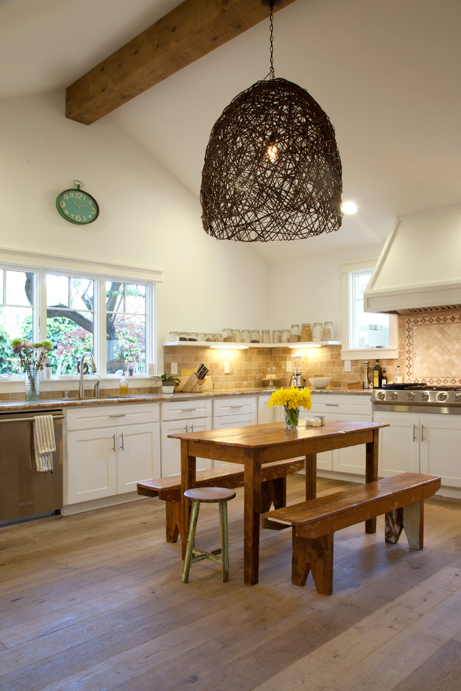 Photo of a contemporary eat-in kitchen in San Francisco with shaker cabinets, white cabinets, beige splashback and stainless steel appliances.