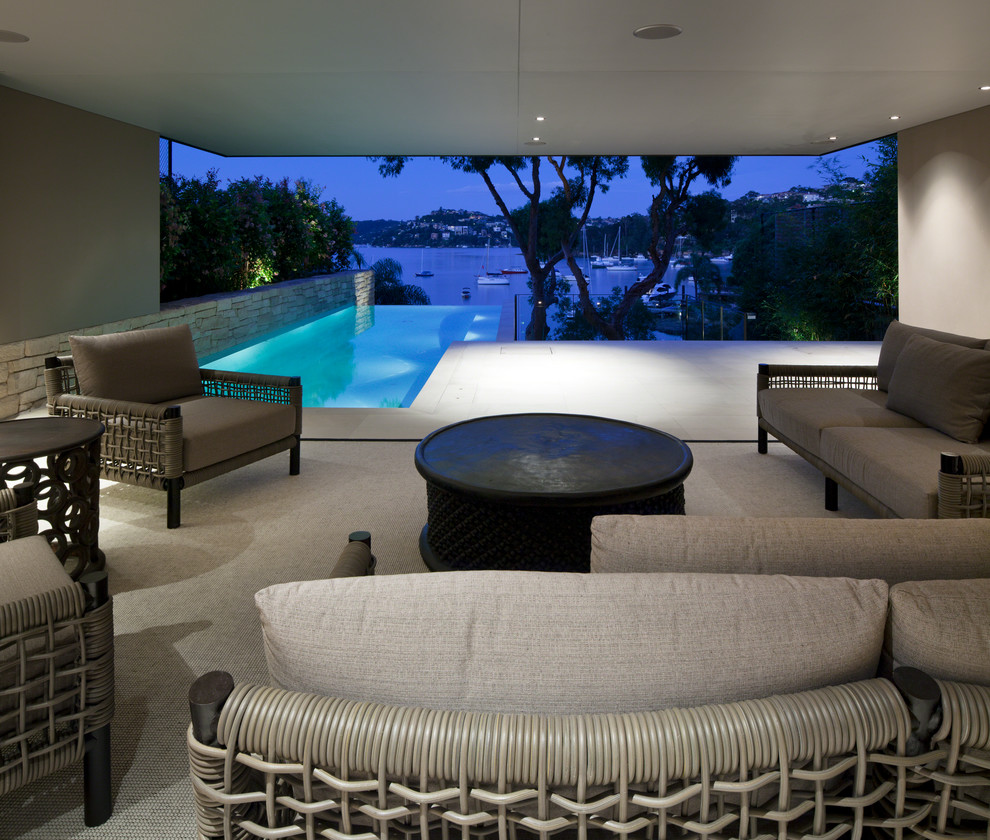 Photo of a contemporary backyard rectangular infinity pool in Sydney.