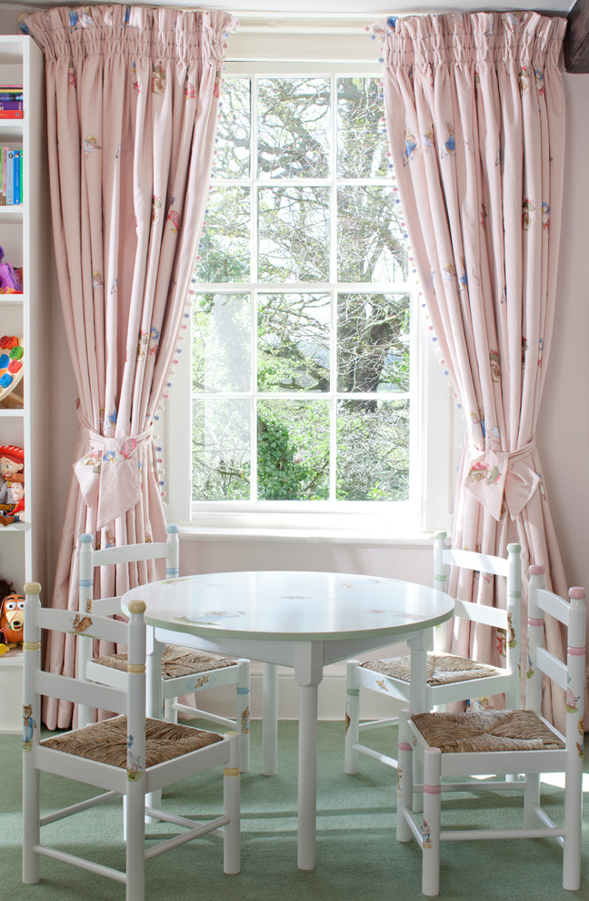 Design ideas for a country kids' playroom for girls in London with carpet and green floor.