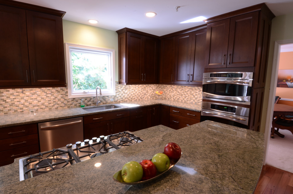 Mid-sized transitional l-shaped dark wood floor and brown floor eat-in kitchen photo in Baltimore with an undermount sink, shaker cabinets, dark wood cabinets, granite countertops, multicolored backsplash, matchstick tile backsplash, stainless steel appliances and an island