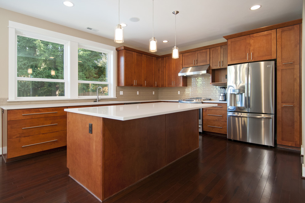 Inspiration for a mid-sized transitional u-shaped dark wood floor open concept kitchen remodel in Seattle with an undermount sink, recessed-panel cabinets, medium tone wood cabinets, quartzite countertops, beige backsplash, stainless steel appliances, beige walls and an island