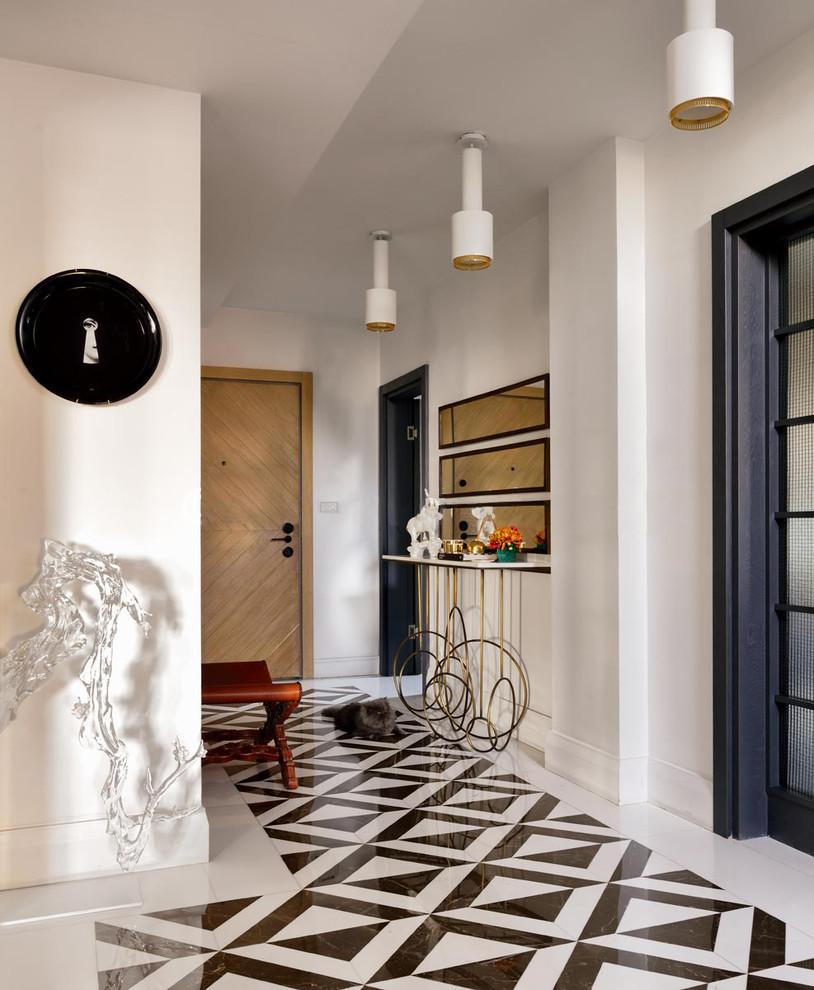 Inspiration for a mid-sized transitional marble floor and black floor entry hall remodel with white walls and a medium wood front door