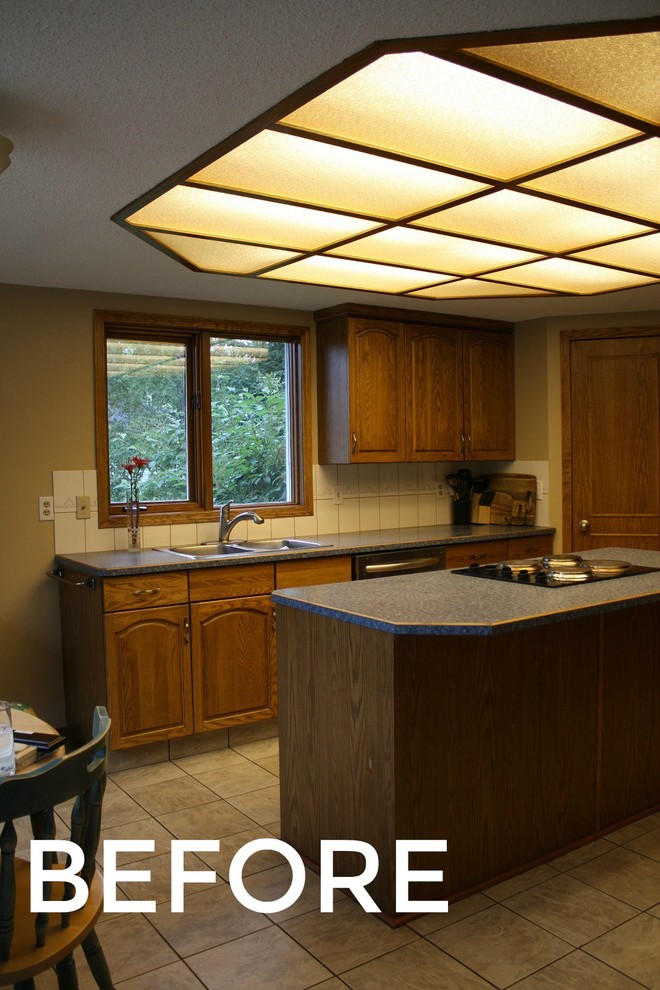 Example of a small transitional eat-in kitchen design with raised-panel cabinets, brown cabinets, granite countertops, stainless steel appliances and an island