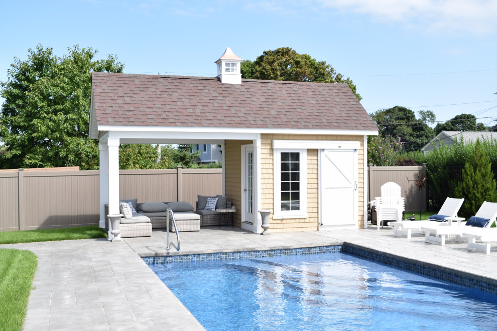 Photo of a mid-sized transitional backyard custom-shaped pool in Boston with a pool house and concrete pavers.