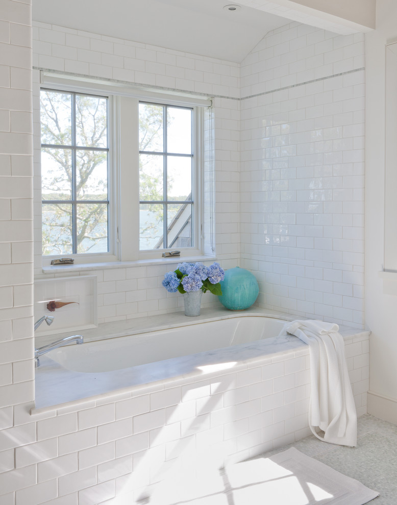 Inspiration for a beach style bathroom in New York with subway tile, white tile and an undermount tub.