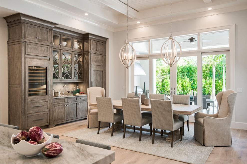 Transitional light wood floor great room photo with shaker cabinets, gray cabinets, stainless steel appliances and an island