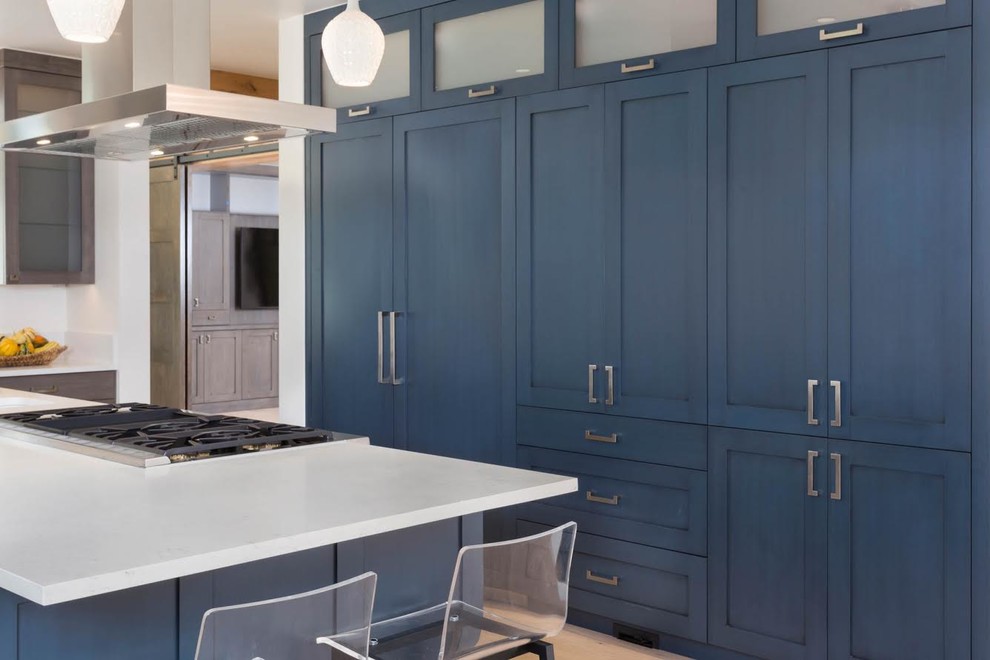Example of a transitional kitchen design in Denver with blue cabinets