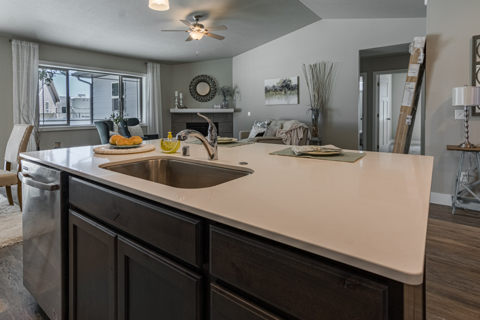 Eat-in kitchen - mid-sized transitional l-shaped vinyl floor and gray floor eat-in kitchen idea with an undermount sink, shaker cabinets, dark wood cabinets, quartz countertops, quartz backsplash, stainless steel appliances, an island and white countertops