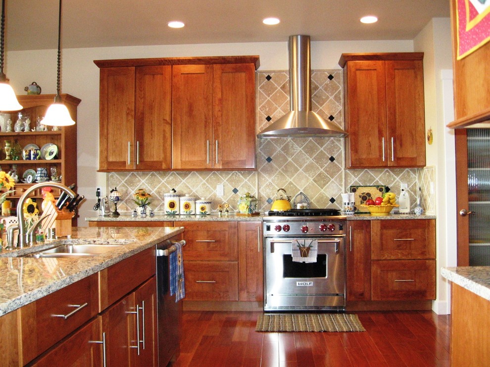Example of a transitional kitchen design in Seattle with an undermount sink, shaker cabinets, granite countertops, beige backsplash and stone tile backsplash