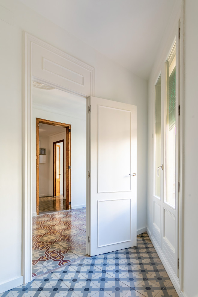 Photo of a small mediterranean master bedroom in Barcelona with white walls, ceramic floors and grey floor.