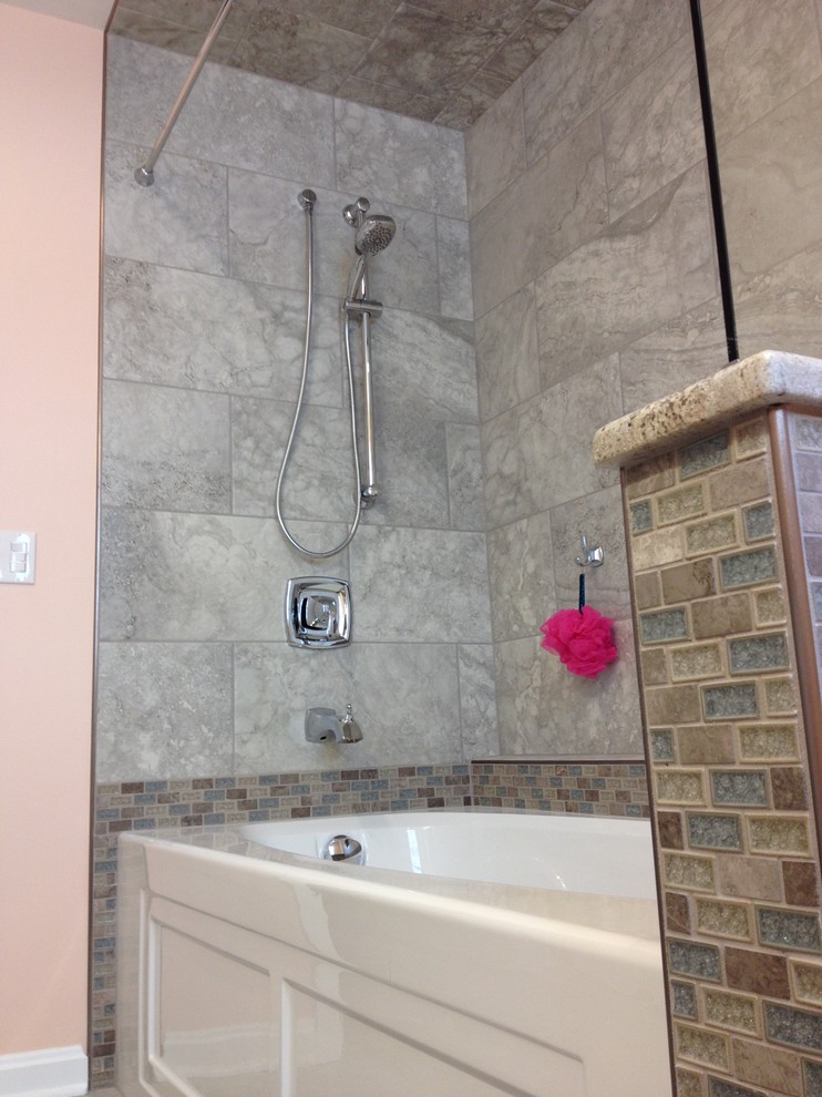 Alcove bathtub - mid-sized transitional kids' gray tile and porcelain tile porcelain tile alcove bathtub idea with an undermount sink, raised-panel cabinets, white cabinets, granite countertops and orange walls