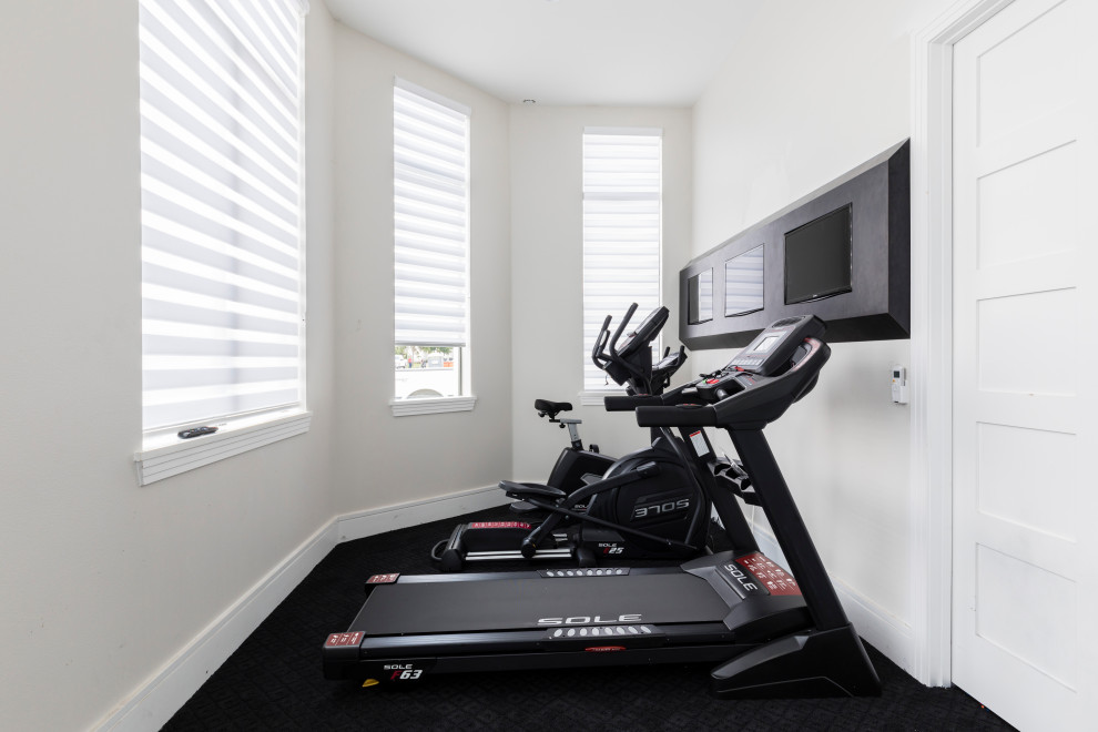 Inspiration for a small contemporary multipurpose gym in Orlando with white walls, carpet and black floor.