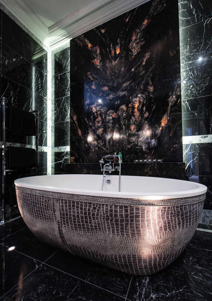 Design ideas for a large contemporary master bathroom in Cheshire with a freestanding tub, marble floors and black tile.