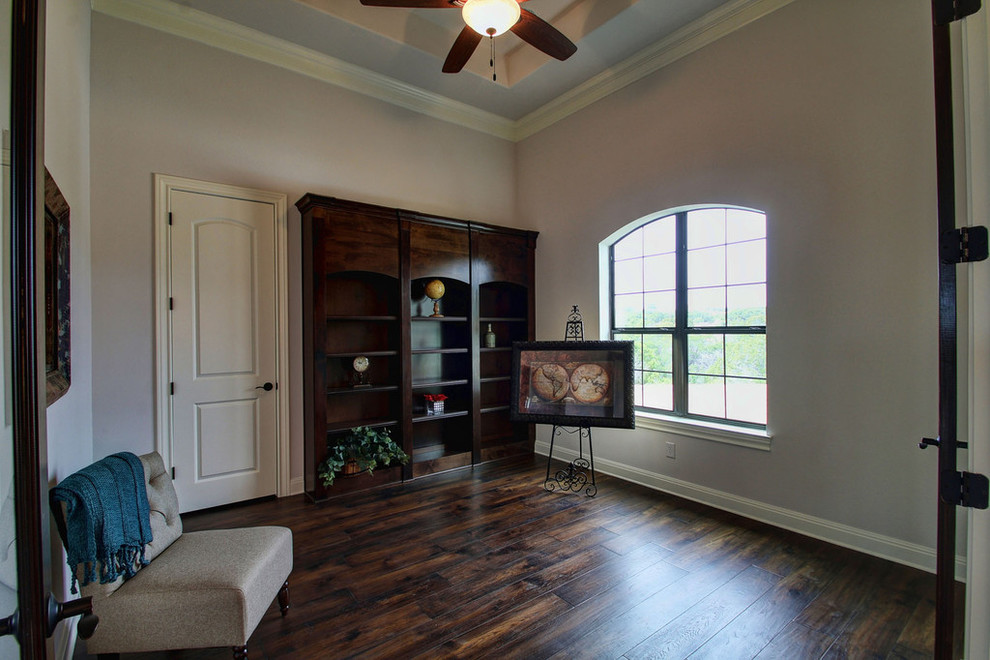 Inspiration for a traditional home office in Austin with beige walls, dark hardwood floors and brown floor.