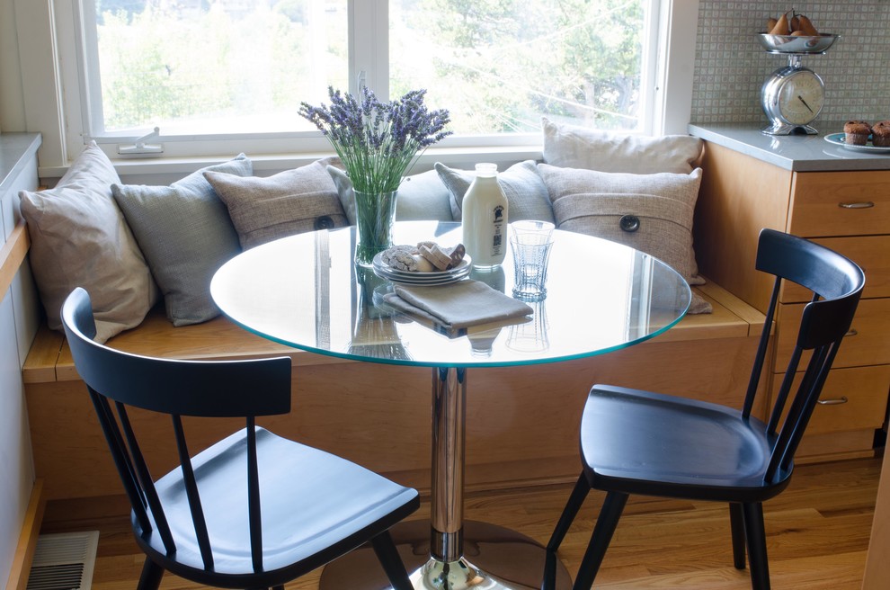 Example of a mid-sized transitional u-shaped light wood floor eat-in kitchen design in Seattle with an undermount sink, shaker cabinets, light wood cabinets, quartz countertops, mosaic tile backsplash, stainless steel appliances and a peninsula