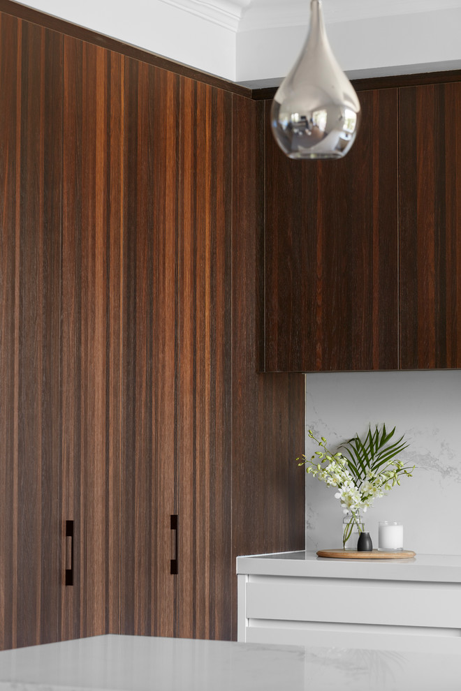 Inspiration for a large contemporary u-shaped kitchen pantry in Melbourne with a double-bowl sink, flat-panel cabinets, dark wood cabinets, marble benchtops, white splashback, marble splashback, stainless steel appliances, light hardwood floors, with island and white benchtop.