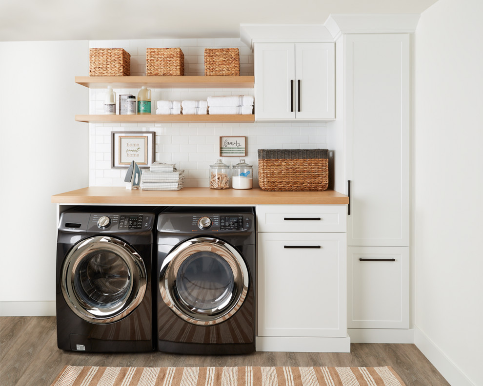 Design ideas for a contemporary laundry room in Burlington with white cabinets and white walls.