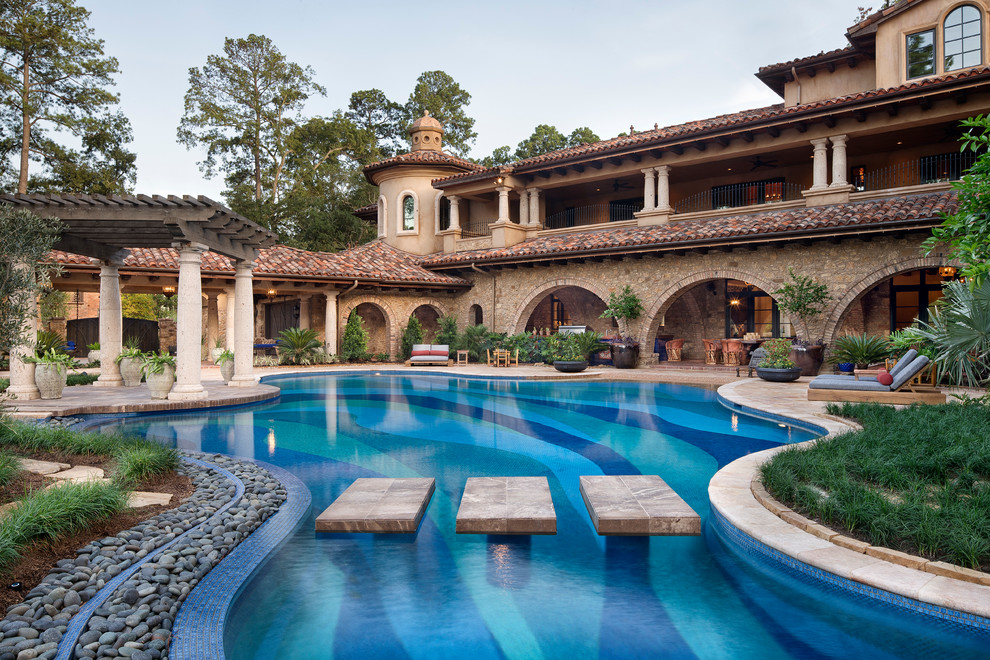 Inspiration for an expansive mediterranean backyard custom-shaped pool in Houston.
