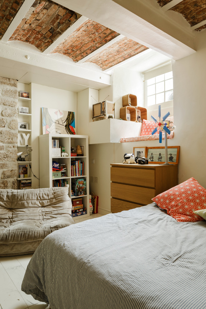 This is an example of a mid-sized country kids' room for boys in Paris with multi-coloured walls and painted wood floors.