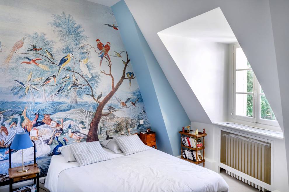 Example of a trendy loft-style beige floor, vaulted ceiling and wallpaper bedroom design in Other with blue walls